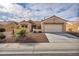 This lovely single-story house showcases a terra cotta roof and easy-care desert landscaping with an attached two car garage at 2345 Hot Brook Point St, Las Vegas, NV 89134
