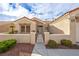 Charming single-story home featuring a terra cotta roof and well-maintained desert landscaping with gated front entrance at 2345 Hot Brook Point St, Las Vegas, NV 89134