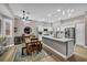 Spacious kitchen flows into the dining area featuring modern appliances, island seating, and contemporary decor at 2345 Hot Brook Point St, Las Vegas, NV 89134