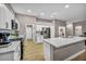 Bright kitchen boasts stainless steel appliances, an island with seating, and ample counter space for meal preparation at 2345 Hot Brook Point St, Las Vegas, NV 89134