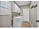 Functional laundry room with white cabinets, in-unit washer and dryer, and wood-look flooring at 2345 Hot Brook Point St, Las Vegas, NV 89134