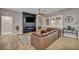 Bright living room with a stylish fireplace, large TV, and comfortable leather sectional sofa at 2345 Hot Brook Point St, Las Vegas, NV 89134