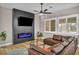 Cozy living room features a modern fireplace, mounted TV, and comfortable leather sectional at 2345 Hot Brook Point St, Las Vegas, NV 89134