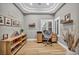 Bright home office with a modern desk setup, wood-style floors, and ample natural light at 2345 Hot Brook Point St, Las Vegas, NV 89134