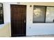 Exterior of apartment featuring a dark wooden door with security grate and windows at 2724 Otter Creek Ct # 101, Las Vegas, NV 89117