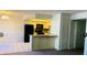 Open-concept kitchen with black appliances and a breakfast bar at 2724 Otter Creek Ct # 101, Las Vegas, NV 89117