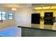 Kitchen featuring a breakfast bar, black appliances and tile floors at 2724 Otter Creek Ct # 101, Las Vegas, NV 89117