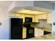 Bright kitchen features granite countertops, black appliances, and neutral cabinets at 2724 Otter Creek Ct # 101, Las Vegas, NV 89117