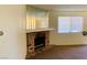 A living room featuring a brick fireplace and large window at 2724 Otter Creek Ct # 101, Las Vegas, NV 89117