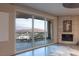 Living space with incredible city view and balcony access, with fireplace, and comfortable seating at 2777 Paradise Rd # Ph 3001, Las Vegas, NV 89109