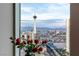 Breathtaking city view featuring iconic landmarks from the condo's large picture window, enhanced by beautiful red roses at 2777 Paradise Rd # Ph 3001, Las Vegas, NV 89109