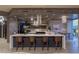 A modern kitchen with a large island, seating, dark cabinets and a dining area with spectacular city views at 2777 Paradise Rd # Ph 3001, Las Vegas, NV 89109