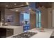 Modern kitchen with stainless steel range hood and a dining area with city views through large windows at 2777 Paradise Rd # Ph 3001, Las Vegas, NV 89109