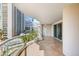 Spacious balcony featuring tile flooring, glass railings, and views of city buildings and lush green palm trees at 2857 Paradise Rd # 601, Las Vegas, NV 89109