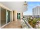 Condo balcony with glass railing and tile floor showcases cityscape and palm tree views at 2857 Paradise Rd # 601, Las Vegas, NV 89109
