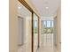 Hallway with closet mirrors that leads to a room with big windows at 2857 Paradise Rd # 601, Las Vegas, NV 89109