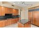 Contemporary kitchen showcasing wooden cabinetry, stainless steel appliances, and granite island at 2857 Paradise Rd # 601, Las Vegas, NV 89109