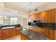 Well-equipped kitchen featuring wood cabinetry, granite countertops, and a central island at 2857 Paradise Rd # 601, Las Vegas, NV 89109