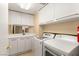 Well-equipped laundry room with modern washer, dryer, and storage cabinets at 2857 Paradise Rd # 601, Las Vegas, NV 89109
