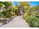 Landscaped backyard features stone path, privacy landscaping, and a small playhouse at 3001 Astoria Pines Cir, Las Vegas, NV 89107