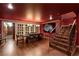 Basement featuring dining table under chandelier and access to wine cellar via wooden staircase at 3001 Astoria Pines Cir, Las Vegas, NV 89107
