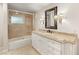 Bathroom with a shower over tub, granite vanity top and light tile floors at 3001 Astoria Pines Cir, Las Vegas, NV 89107