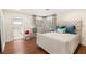 Bedroom features wood floors, upholstered headboard, and doorway to the ensuite bathroom at 3001 Astoria Pines Cir, Las Vegas, NV 89107
