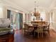 Formal dining room with hardwood floors, elegant chandelier, and french doors at 3001 Astoria Pines Cir, Las Vegas, NV 89107
