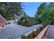 View of the large paved patio, lush vegetation, and part of the estate at 3001 Astoria Pines Cir, Las Vegas, NV 89107