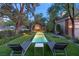 Modern backyard with a pool, lounge chairs, and manicured landscaping at 3001 Astoria Pines Cir, Las Vegas, NV 89107