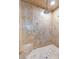 Shower featuring a stone tile wall, rain head shower fixture, and built-in stone seat at 3001 Astoria Pines Cir, Las Vegas, NV 89107