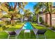 Backyard retreat featuring a long swimming pool, lounge chairs, and manicured landscaping at 3001 Astoria Pines Cir, Las Vegas, NV 89107