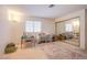 Neutral bedroom with mirrored closet doors, window, and space for versatile furniture arrangements at 3455 Erva St # 219, Las Vegas, NV 89117