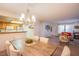 Bright dining area with a wooden table, seating for six and an open plan to kitchen at 3455 Erva St # 219, Las Vegas, NV 89117