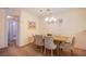 Cozy dining area with seating for six and modern chandelier at 3455 Erva St # 219, Las Vegas, NV 89117