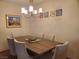 Formal dining room with seating for six, a wooden table, and stylish overhead lighting at 3455 Erva St # 219, Las Vegas, NV 89117