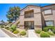 Condo building featuring landscaped grounds, stairs to units, and neutral stucco at 3455 Erva St # 219, Las Vegas, NV 89117