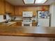 Functional kitchen with a breakfast bar, white appliances, and ample cabinet storage space at 3455 Erva St # 219, Las Vegas, NV 89117