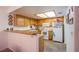 Functional kitchen with a breakfast bar, tile flooring, and white appliances at 3455 Erva St # 219, Las Vegas, NV 89117