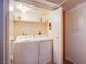 Dedicated laundry room includes a washing machine, dryer, and shelving for storage and organization at 3455 Erva St # 219, Las Vegas, NV 89117