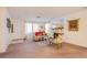 Bright living room with neutral carpet and paint and an inviting fireplace feature at 3455 Erva St # 219, Las Vegas, NV 89117