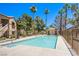 Inviting community pool is surrounded by palm trees, offering a serene retreat for residents and guests at 3455 Erva St # 219, Las Vegas, NV 89117