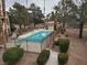 Community pool area provides a relaxing space surrounded by greenery and trees, perfect for leisure activities at 3455 Erva St # 219, Las Vegas, NV 89117