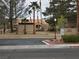 Street view of building with mature landscaping, a street sign, and parking at 3455 Erva St # 219, Las Vegas, NV 89117