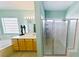 Bright bathroom with a glass enclosed shower and a double sink vanity and block glass window at 3459 Ridge Meadow St, Las Vegas, NV 89135