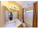 Bathroom with a single sink vanity, tiled bathtub, and a window at 3459 Ridge Meadow St, Las Vegas, NV 89135