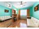 Bedroom with a futon, hardwood floors, window with curtains, and mirrored closets at 3459 Ridge Meadow St, Las Vegas, NV 89135