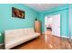 Bedroom with a futon, hardwood floors, and walk in mirrored closets at 3459 Ridge Meadow St, Las Vegas, NV 89135