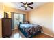 Bedroom with a bed, ceiling fan, and a window with decorative curtains at 3459 Ridge Meadow St, Las Vegas, NV 89135