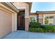 Home exterior featuring front door with security gate, garage, and manicured landscaping at 3459 Ridge Meadow St, Las Vegas, NV 89135